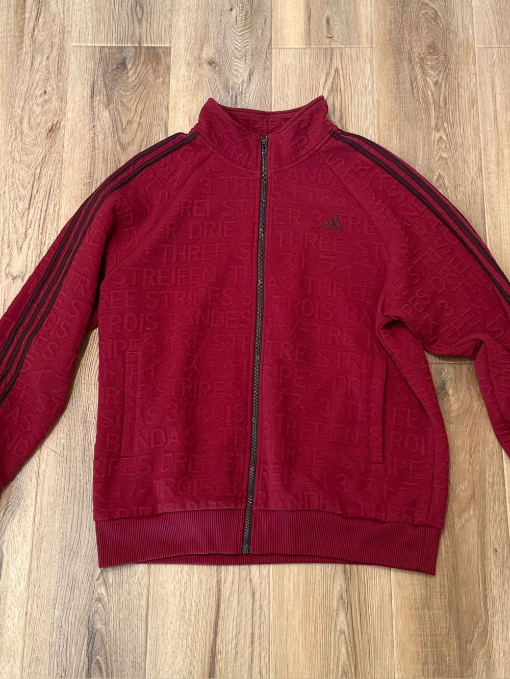 adidas Men's Burgundy Full-Zip Lightweight Track Jacket with Black Stripe.